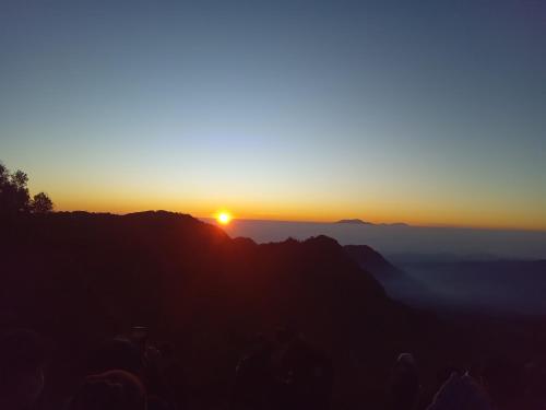 a sunset on the top of a mountain at Dannu's Homestay Ijen and Bromo Tour in Banyuwangi