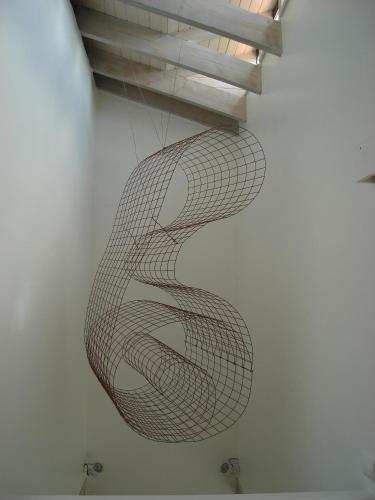 a painting of a spiral on a wall at Las Villas de Cué in Llanes