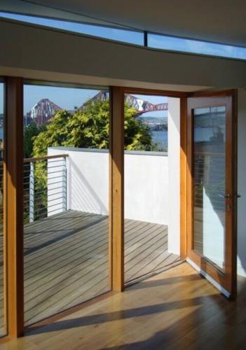 a house with a balcony with a view of the water at The Nook, Studio Apartment, South Queensferry in Queensferry