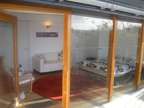 a room with a glass door with a bed in it at The Nook, Studio Apartment, South Queensferry in Queensferry