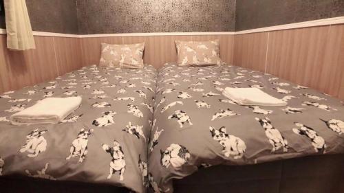 a bed with a blanket with dogs on it at Jing House Koiwa - Vacation STAY 62678v in Tokyo