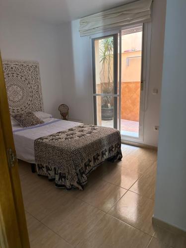 a bedroom with a bed and a sliding glass door at Costa Dorada in Fuengirola