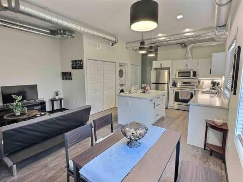 a large kitchen and living room with a table and chairs at Summer Suite - Pet Friendly in Brandon
