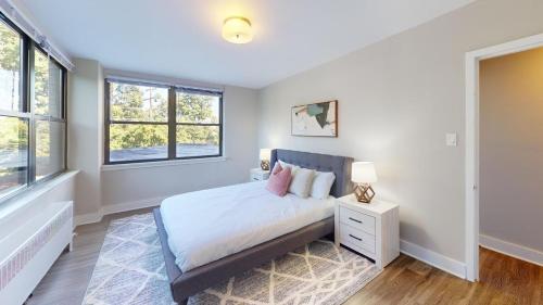 a bedroom with a bed and two windows at Avenue B234 2bedroom With Pool, Gym, Parking in Philadelphia