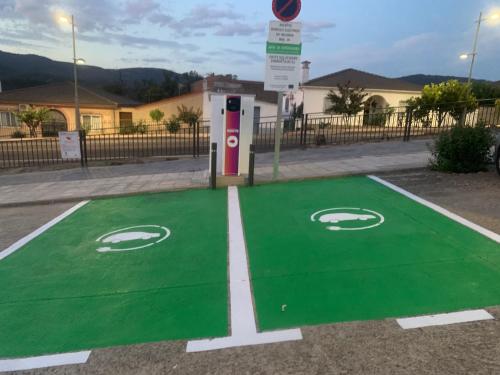 a green parking lot with a gas pump at El Encanto de Abadía in Abadía