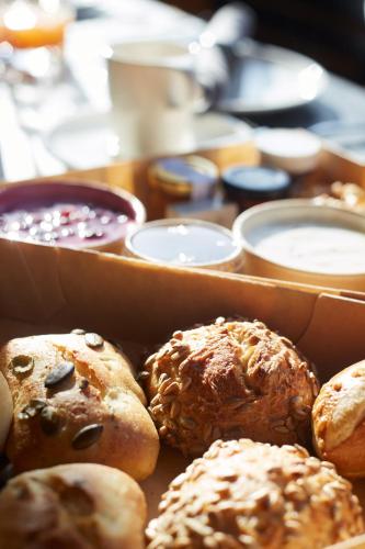 a table with a box of different types of pastries at Alpenstolz Damüls Haus 2 - Stilvoll urlauben in den Bergen in Damuls