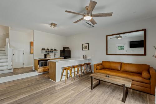 a living room with a couch and a kitchen at The Wells Cashiers in Cashiers