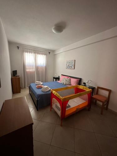 a bedroom with a bed and a table and a chair at Profumo di mare in Càbras