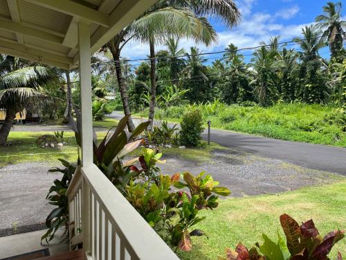 a porch of a house with a view of a street at Aaron’s cottage in Hilo