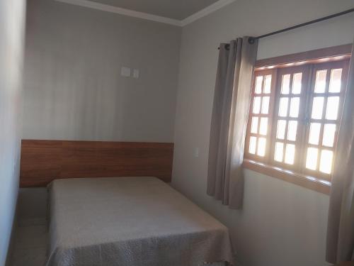 Ένα ή περισσότερα κρεβάτια σε δωμάτιο στο Hotel-Pousada Quartzo Rosa