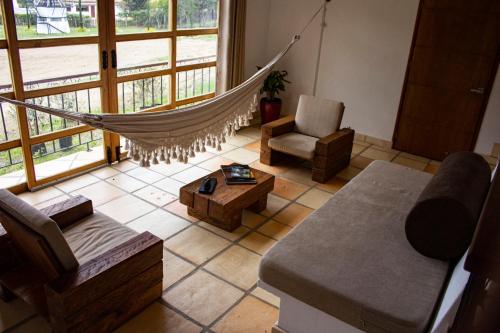 a living room with a hammock and a couch and chair at Hospedaje campestre - El Solaz Suites in Villa de Leyva