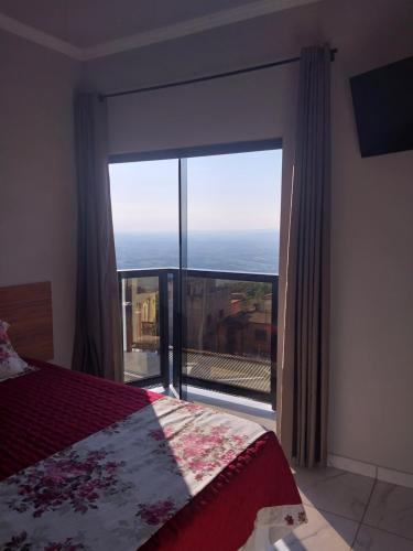 Ένα ή περισσότερα κρεβάτια σε δωμάτιο στο Hotel-Pousada Quartzo Rosa