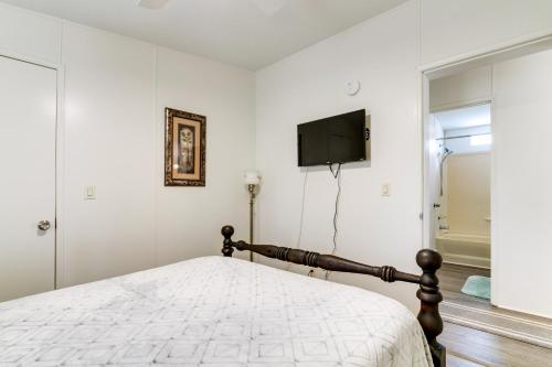 a bedroom with a bed and a tv on the wall at Weeki Wachee Vacation Rental about 13 Mi to the Ocean! in Spring Hill