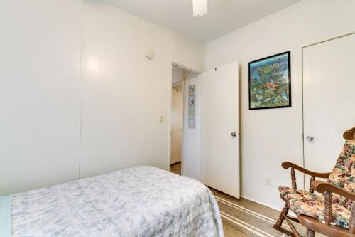 a bedroom with white walls and a bed and a chair at Weeki Wachee Vacation Rental about 13 Mi to the Ocean! in Spring Hill