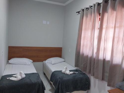Ένα ή περισσότερα κρεβάτια σε δωμάτιο στο Hotel-Pousada Quartzo Rosa