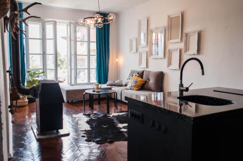 a living room with a sink and a living room with a couch at Villa Mavro Mavrovo in Mavrovo