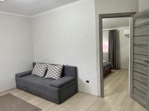 a living room with a couch and a mirror at Готель «У Батька» in Truskavets
