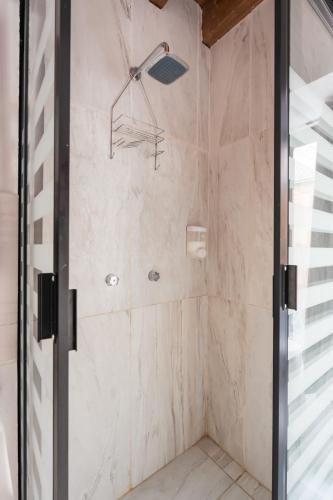 a bathroom with a shower with a glass door at Hostal Juarez in Mexico City