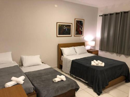 Katil atau katil-katil dalam bilik di L2 Casa condomínio tipo resort frente a praia.