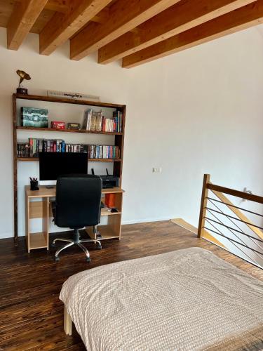 a bedroom with a desk with a computer and a chair at Capstay La Louvière in La Louvière