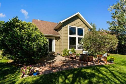 a house with two chairs and a patio in the yard at Peaceful 3BD in heart of Bozeman in Bozeman