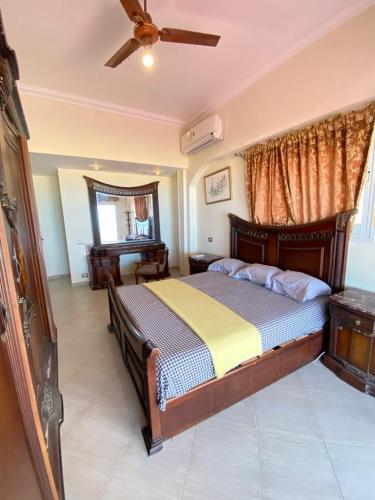 a bedroom with a bed and a ceiling fan at فيلا اول صف بحر مارينا الساحل الشمالي العلمين برايفت بول in El Alamein