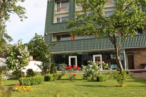 a garden in front of a building at Hotel Jasmine in Braşov