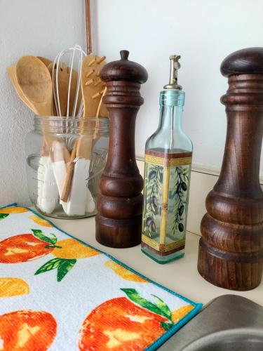 a counter top with two bottles of oil and some bread at Boundless Bliss Hotel in St Thomas