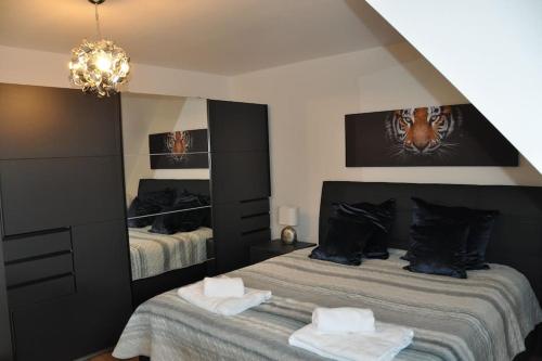 a bedroom with two beds and a chandelier at Wohnung in Eggenstein-Leopoldsh. 