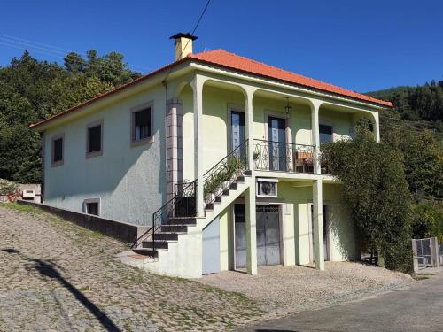 a large house with stairs on the side of it at Casa Calçada in Asnela