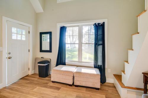 a living room with a window and a bench at Lakefront Center Ossipee Home with Boat Dock! in Center Ossipee