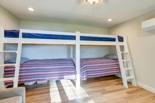 two bunk beds in a room with wooden floors at Lakefront Center Ossipee Home with Boat Dock! in Center Ossipee