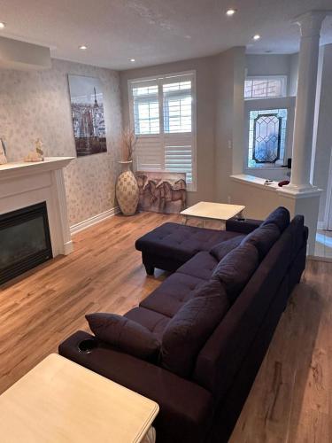 a living room with a couch and a fireplace at Beautiful home in Mississauga