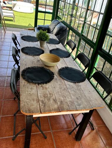 a wooden table with four chairs around it at Casa Rural en Valsequillo in Las Palmas de Gran Canaria