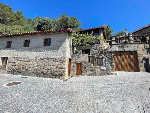 an old stone house with a cobblestone street at Petra's House Gerês in Geres
