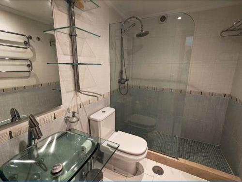 a bathroom with a toilet and a sink and a shower at Sea view penthouse in Fuengirola
