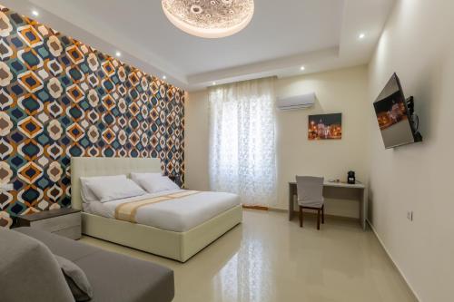a bedroom with a bed and a table with a chair at Hyper Lodge Termini GuestHouse in Rome