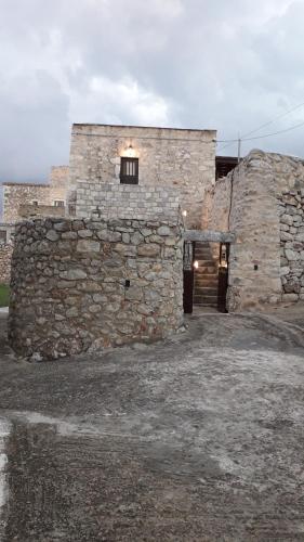 a stone building with a door and a window at Πέτρινο σπίτι-Stone house in Koíta