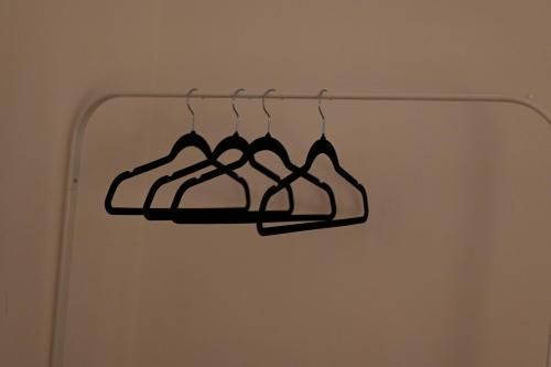 two hangers hanging on a rack in a room at Modern house in City Centre with private parking and gated property in Birmingham