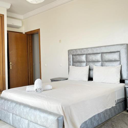 a bedroom with a large bed with white sheets at Best Apartment in Marina Agadir in Agadir