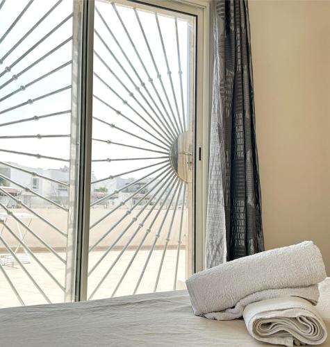 a bedroom with a sliding glass door with a window at Best Apartment in Marina Agadir in Agadir