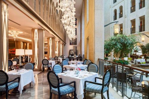 a restaurant with tables and chairs in a building at Waldorf Astoria Jerusalem in Jerusalem