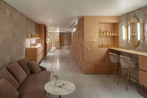 a living room with a couch and a bar at Waldorf Astoria Jerusalem in Jerusalem