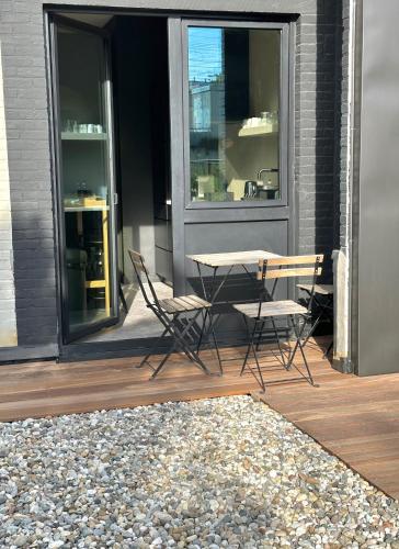 a patio with a table and chairs on a porch at 3 Bedroom Art-Nouveau Apartment with Free Parking in Ghent