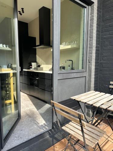 a wooden bench sitting in front of a kitchen at 3 Bedroom Art-Nouveau Apartment with Free Parking in Ghent