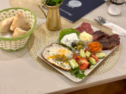 a plate of food with eggs and vegetables on a table at The Place 87 in Sarajevo