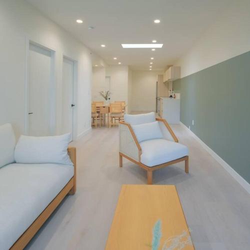 a living room with two chairs and a table at Newly Renovated 2 Bedroom Condo in Japantown! Near Railtown & Gastown! in Vancouver