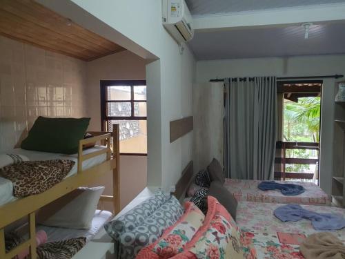 a dorm room with two beds and a window at Pousada Estrela da Manhã in Penha