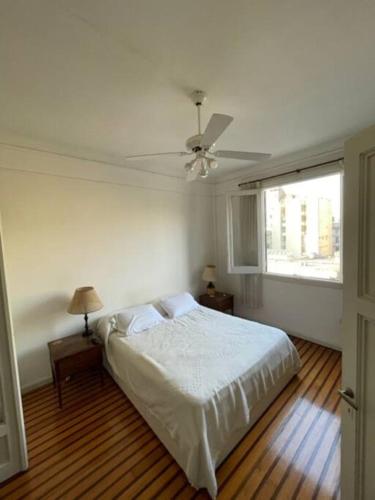 a bedroom with a bed and a ceiling fan at Departamento en San Nicolás in Buenos Aires