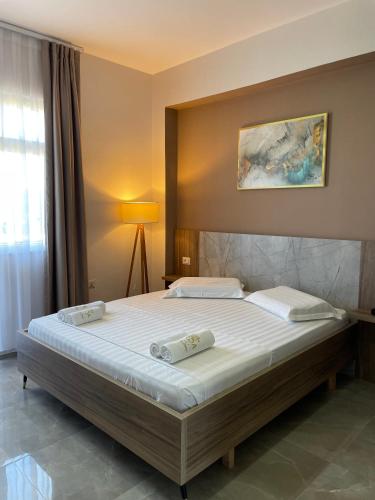 a bedroom with a bed with two pillows on it at Hotel Arda Velipoje in Velipojë